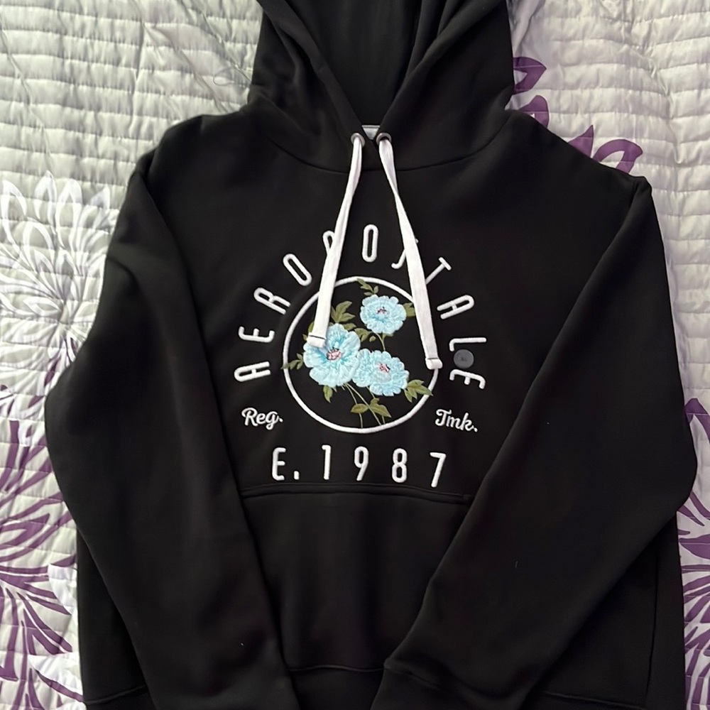 Womens Aeropostale hoodie black with light blue flower detail and logo.
